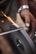 © Connect Images - Close up of man sharpening tool