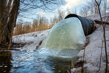 A Culvert Beneath A Road Has Become Mostly Clogged With Ice In Northern Wisconsin