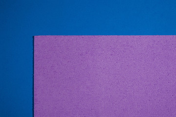 Eva foam ethylene vinyl acetate sponge plush light purple surface on blue smooth background