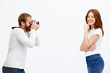 © Cookie Studio - Redhead photographer dressed in white jacket photographing redhe