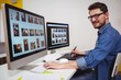 © Wavebreak Media - Portrait of male photo editor working on computer