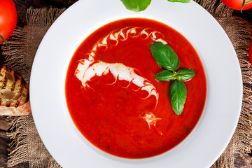 Wall Mural - Smooth and sweet tomato soup, seasoned with basil, garlic.