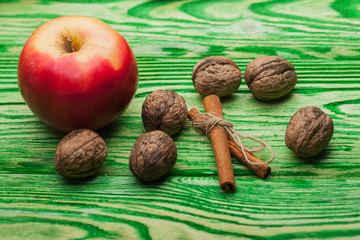 walnut apple and cinnamon on green wood