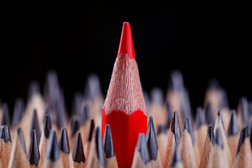 one sharpened red pencil among many ones