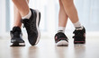 © smallblackcat - Child's and woman's legs in sports shoes