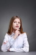 © azhurfoto - Portrait of a cute young student girl with pondering gesture.