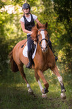Fototapeta Konie - Girl riding a horse