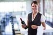 © WavebreakMediaMicro - Waitress holding a bottle of red wine and a napkin