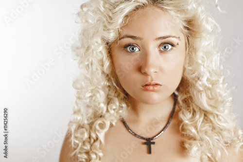Handsome Young Woman In White Dress With Curly Hair Looking
