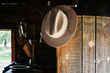 © Tyler Sharp - Cowboy hat hanging on open door