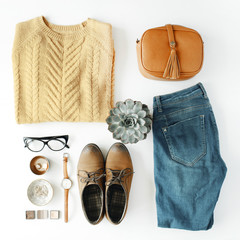 Wall Mural - flat lay feminini clothes and accessories collage with brown cardigan, jeans, glasses, watch, earrings, purse, boots and succulent on white background.
