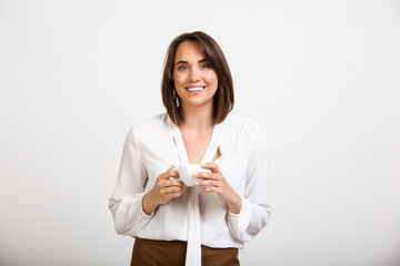 Portrait of young successful business woman over white backgroun