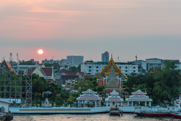 Sticker - Elevated view of Wat Arun, Temple of Dawn,  complex and wharf with sunset sky on the background. Urban Bangkok scene with Buddhist temple