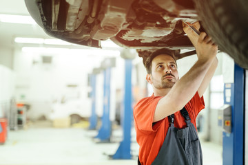 Wall Mural - Car mechanic upkeeping car