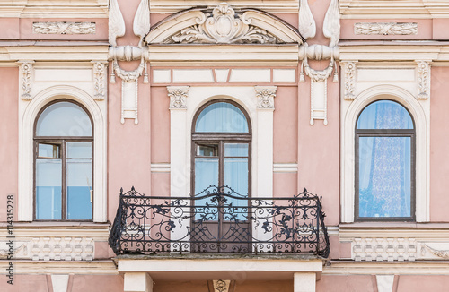 Three Windows In A Row And Balcony On Facade Of Urban Apartment Balcony On Facade Of Urban Apartment