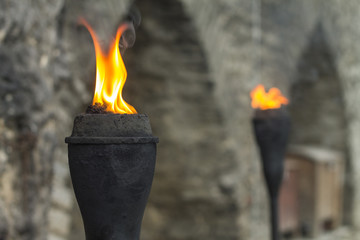 Ancient wall highlighted by pair of iron torch in Tallinn Old Town