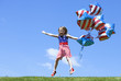 © Olesya Shelomova - Cheerful American  girl with balloons jumping outside. 4th of July. Independence day.
