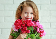 Beautiful Girl Holding Fresh Peonies Bouquet On Brick Wall Background