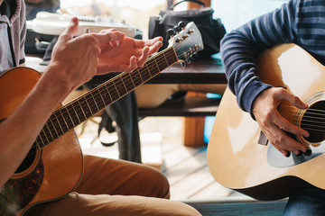 Wall Mural - Learning to play the guitar. Music education and extra-curricular lessons.