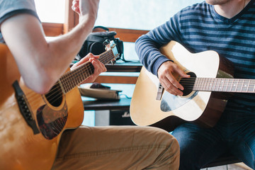 Wall Mural - Learning to play the guitar. Music education and extra-curricular lessons.