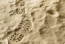 Close Up Boot Or Shoe Print With Grip Set Deeply Into Dirty Sand, Left Side.
