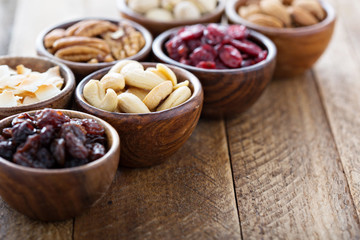 Wall Mural - Variety of nuts and dried fruits in small bowls