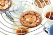 © tktyfy - freshly baked chocolate muffins cooling off on wire mesh