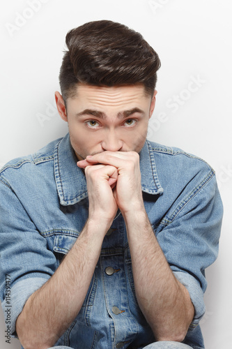 Closeup portrait of handsome man with black hair posing for fashion and vogue magazine with different haircuts Fototapete