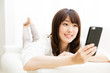 © taka - attractive asian woman using smart phone