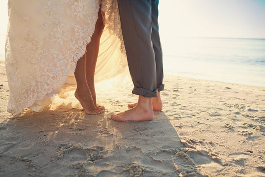 Bride and groom are standing at the beach