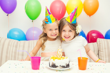 Birthday girl and her friend enjoying a birthday party