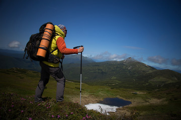 Summer hiking in the mountains with a backpack and tent.