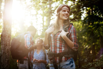 Wall Mural - group of people hiking in forest