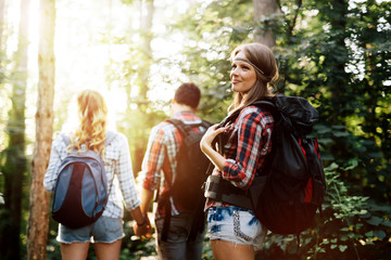Wall Mural - group of people hiking in forest