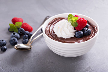 Chocolate pudding with whipped cream and berries