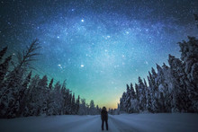 Rear View Of Man Standing On Snowy Landscape Against Starry Sky
