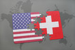 puzzle with the national flag of united states of america and switzerland on a world map background