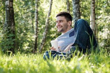 Man with coffee in park