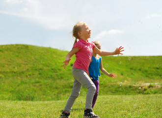 group of happy kids running outdoors