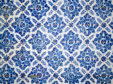 Fototapeta  - A piece of an old blue floral ceramic tile in Portugal on the wa