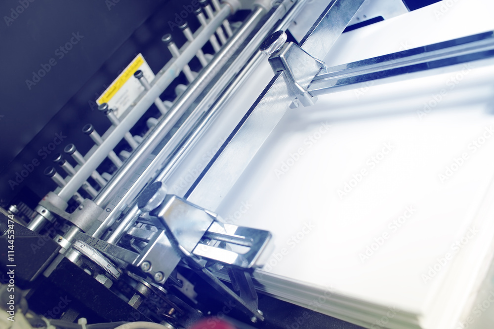 Offset Print Stack Paper stack in bin of offset printing press Stock Photo | Adobe Stock