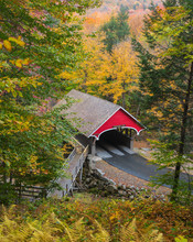 New Hampshire Covered Bridge - The Red Covered Wooden Bridge Across The Pemigewassett River In The White Mountains Of New Hampshire Stands Out Aginst Colorful Autumn Foliage.