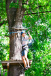 © davit85 - adventure climbing high wire park - people on course in mountain