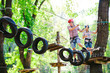 © davit85 - adventure climbing high wire park - people on course in mountain