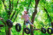 © davit85 - adventure climbing high wire park - people on course in mountain