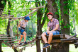 © davit85 - adventure climbing high wire park - people on course in mountain