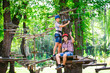 © davit85 - adventure climbing high wire park - people on course in mountain