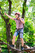© davit85 - adventure climbing high wire park - people on course in mountain