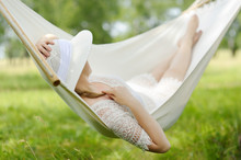 Woman Resting In Hammock Outdoors. Caucasian Woman Relaxing In H