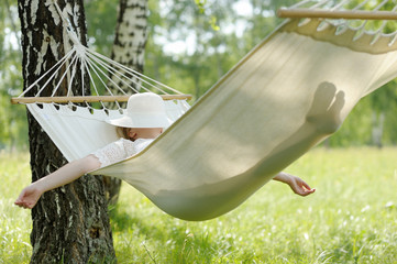 woman resting in hammock.